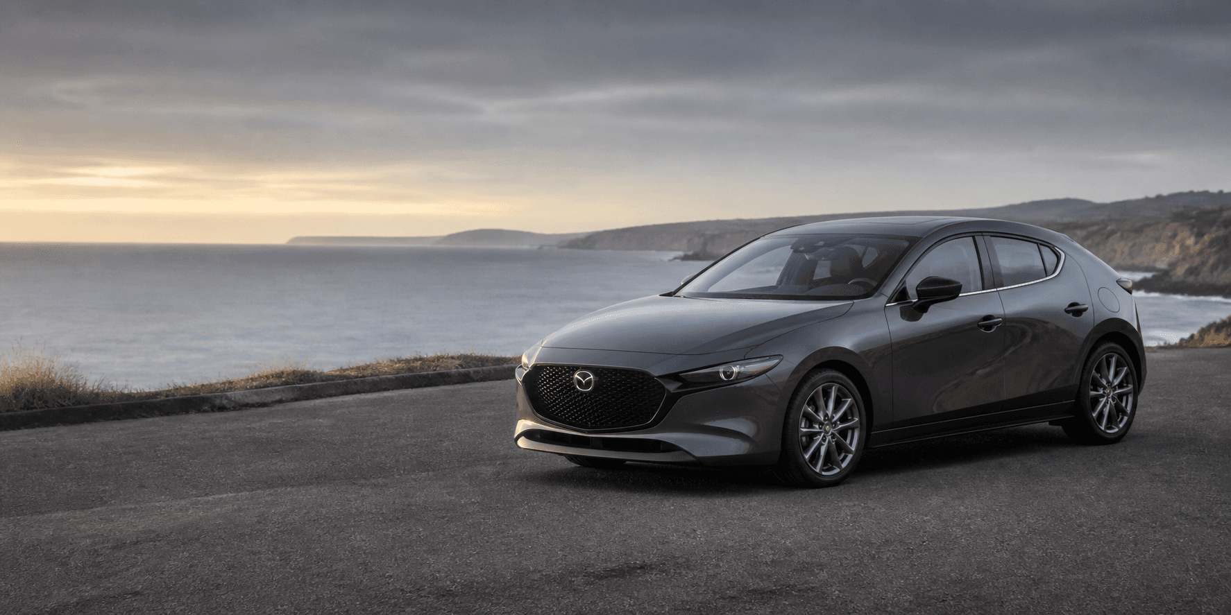 Grey Mazda 3 overlooking the coast